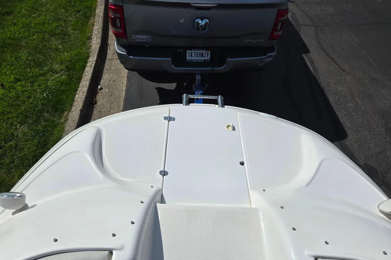 Slide: The Image of 2006 Glastron DX 235 boat hitched to a truck on a sunny day. - 19