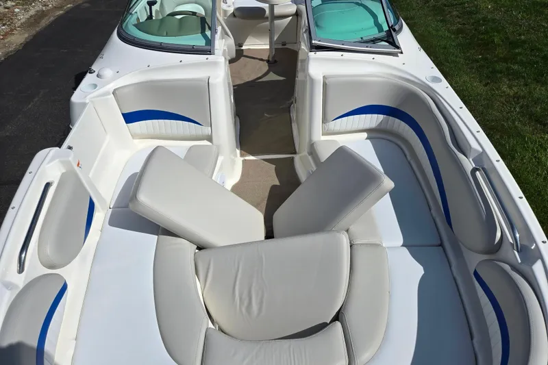Slide: The Image of 2006 Glastron DX 235 boat interior with white and blue seating arrangement. - 20