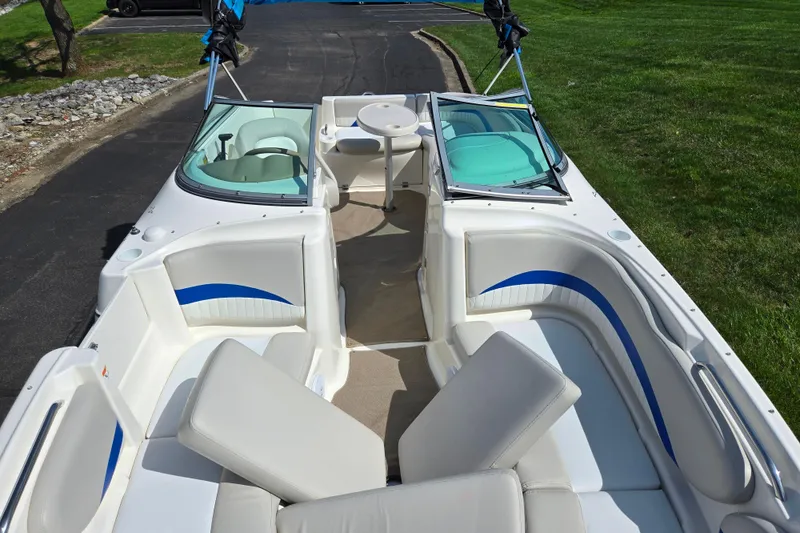 Slide: The Image of 2006 Glastron DX 235 boat interior with white seating and blue accents. - 21