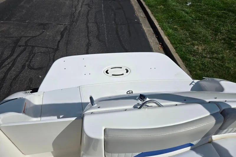 Slide: The Image of 2006 Glastron DX 235 boat rear deck view, featuring white seating and sleek design. - 24