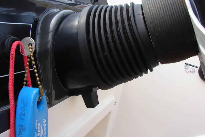 Slide: The Image of Close-up of a 2021 Bayliner VR4 Bowrider I/O engine component with keychain. - 19