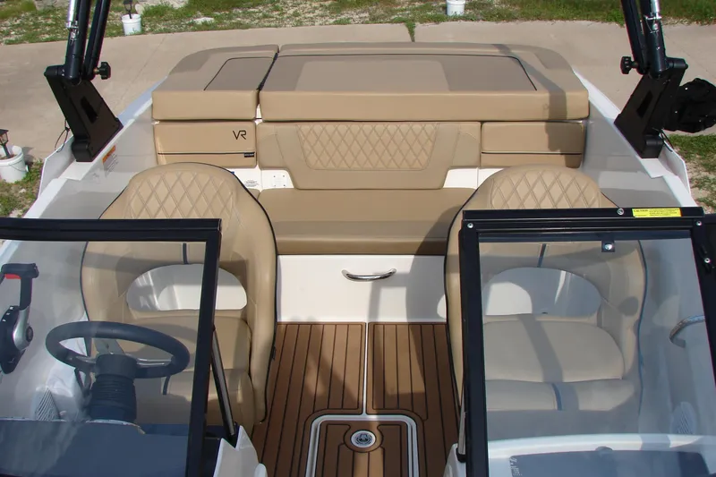Slide: The Image of 2021 Bayliner VR4 Bowrider I/O interior with tan seating and wood-style flooring. - 28