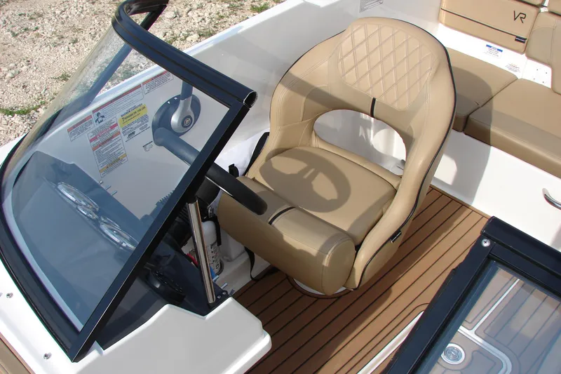 Slide: The Image of 2021 Bayliner VR4 Bowrider I/O cockpit with tan seating and steering wheel. - 29