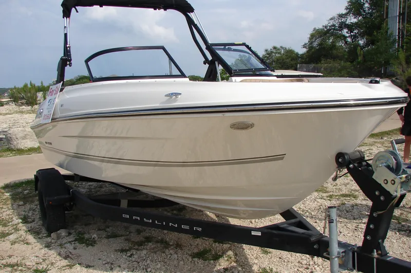 Slide: The Image of 2021 Bayliner VR4 Bowrider I/O boat on trailer, displayed outdoors. - 3