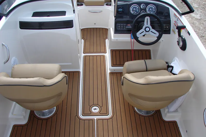 Slide: The Image of 2021 Bayliner VR4 Bowrider I/O interior with tan seats and wood-style flooring. - 34