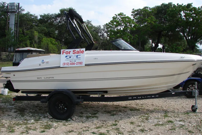 Slide: The Image of 2021 Bayliner VR4 Bowrider I/O boat for sale on trailer, outdoor setting. - 4