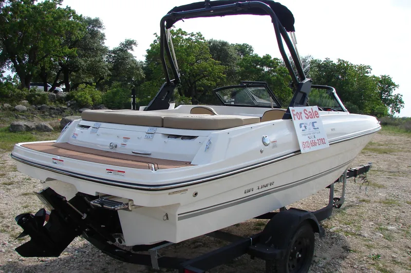 Slide: The Image of 2021 Bayliner VR4 Bowrider I/O boat for sale, parked on a trailer outdoors. - 5