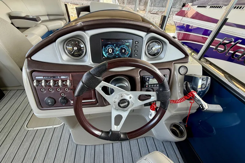 Slide: The Image of Steering console of a 2017 South Bay 725 RS boat with modern controls and gauges. - 11