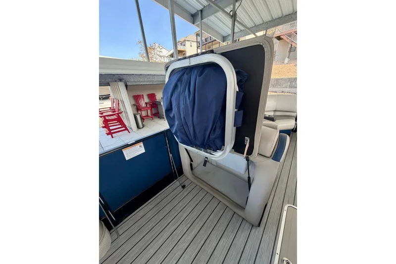 Slide: The Image of 2017 South Bay 725 RS boat interior with seating and storage compartment. - 16