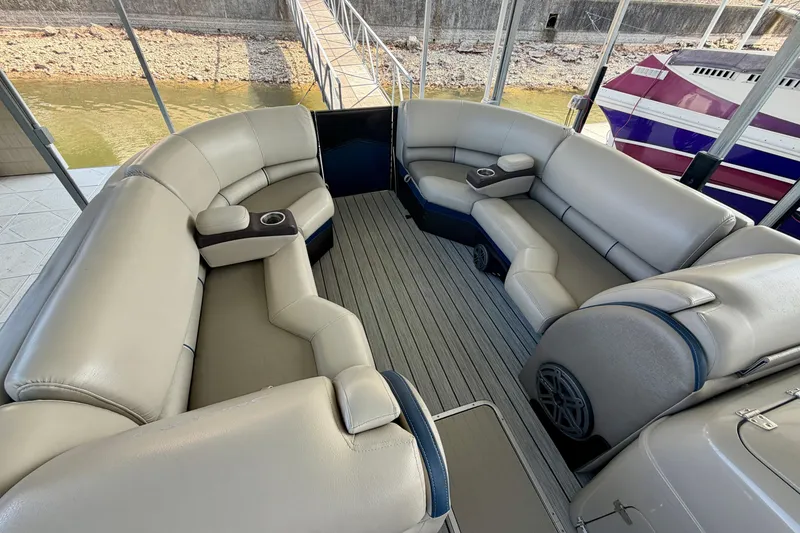 Slide: The Image of Luxurious seating on a 2017 South Bay 725 RS pontoon boat, docked by the water. - 19