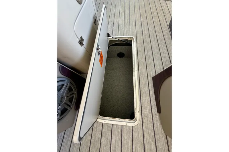 Slide: The Image of Open storage compartment on 2017 South Bay 725 RS boat with striped flooring. - 20