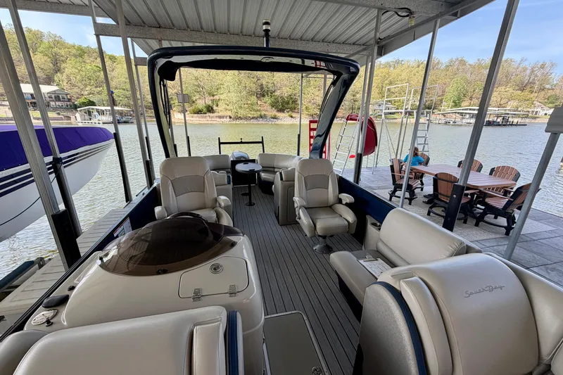 Slide: The Image of 2017 South Bay 725 RS pontoon boat docked, featuring luxurious seating and scenic lake view. - 22