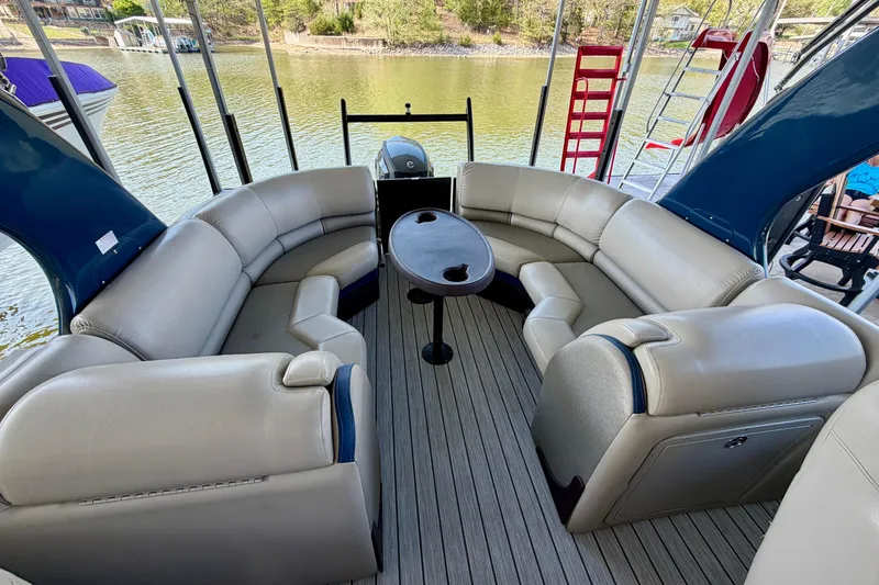 Slide: The Image of Luxurious seating area on a 2017 South Bay 725 RS pontoon boat, overlooking a serene lake. - 23
