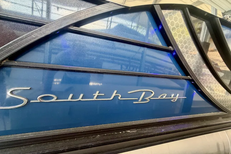 Slide: The Image of Close-up of 2017 South Bay 725 RS boat logo on blue panel. - 31