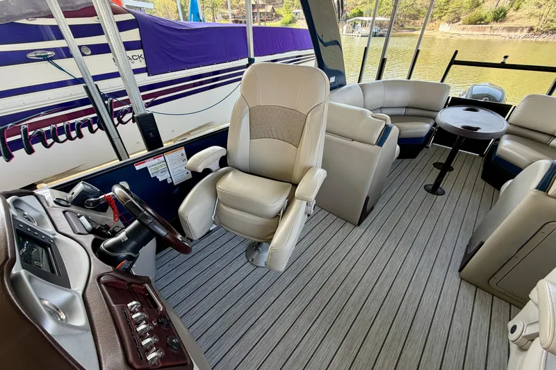 Slide: The Image of 2017 South Bay 725 RS boat interior with captain's chair and seating area. - 8