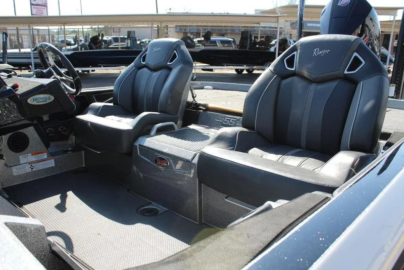 Slide: The Image of 2023 Ranger Z521R boat interior with two black seats and steering wheel. - 10