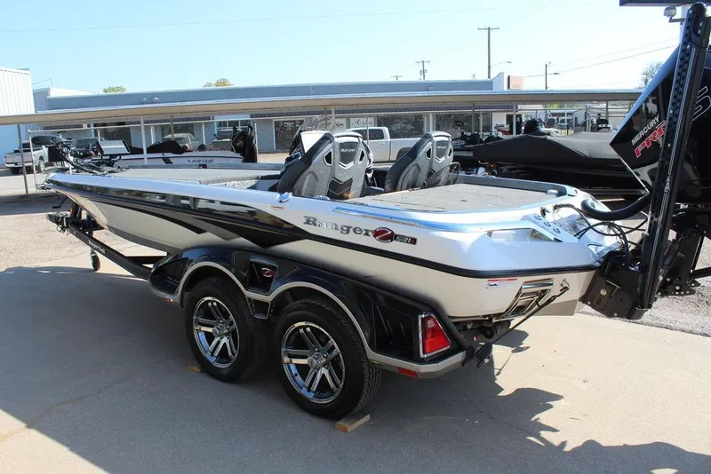 Slide: The Image of 2023 Ranger Z521R boat with dual axle trailer, parked outdoors. - 11