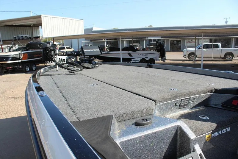 Slide: The Image of 2023 Ranger Z521R boat deck with Minn Kota trolling motor in a dealership lot. - 12