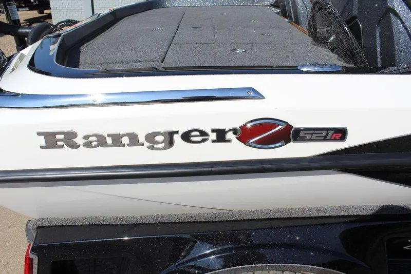 Slide: The Image of 2023 Ranger Z521R boat logo on white exterior with chrome accents. - 13