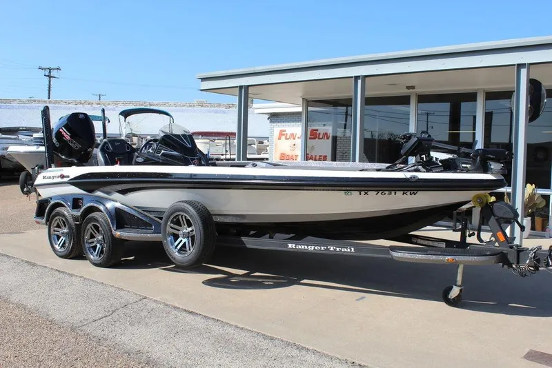 Slide: The Image of 2023 Ranger Z521R boat on trailer outside dealership, showcasing sleek design and modern features. - 2
