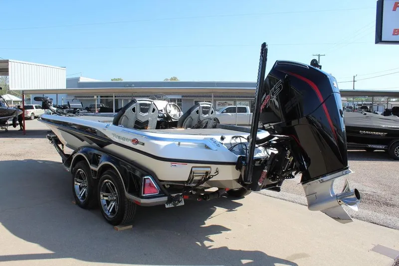 Slide: The Image of 2023 Ranger Z521R boat with powerful engine, parked on a trailer in a dealership lot. - 3