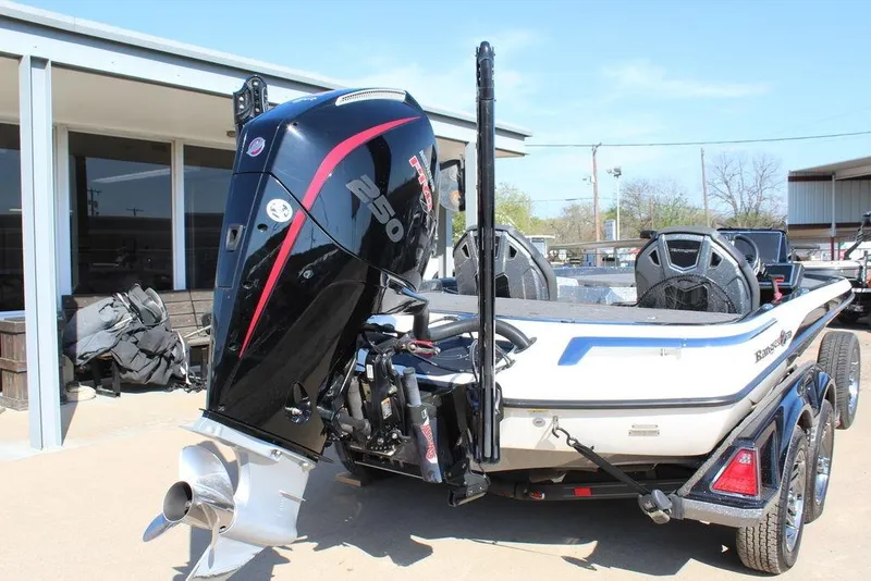Slide: The Image of 2023 Ranger Z521R boat with powerful outboard motor, parked outdoors. - 4