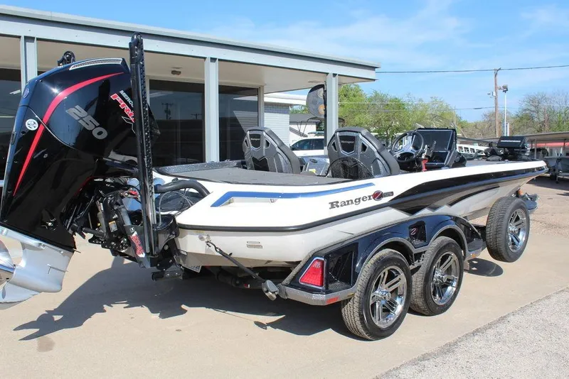 Slide: The Image of 2023 Ranger Z521R boat with powerful engine and sleek design, parked outdoors. - 5