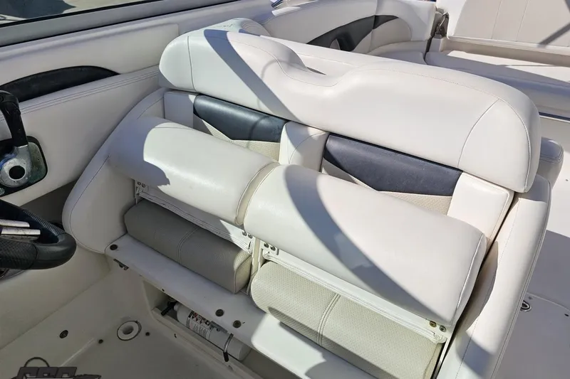 Slide: The Image of 2010 Chaparral 276 SSX boat interior with white leather seating and steering wheel. - 100