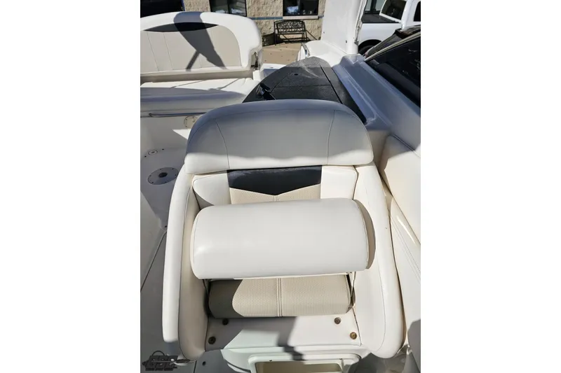 Slide: The Image of 2010 Chaparral 276 SSX boat interior with white cushioned seating. - 102