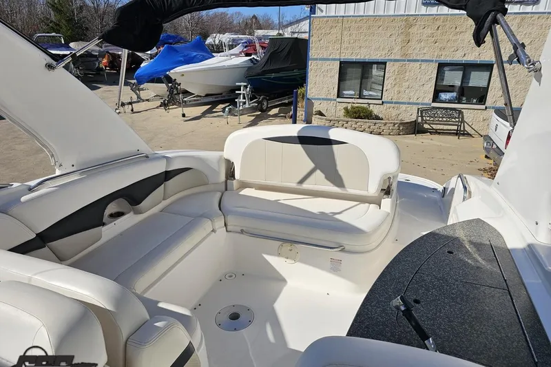 Slide: The Image of 2010 Chaparral 276 SSX boat interior with white seating and outdoor setting. - 103