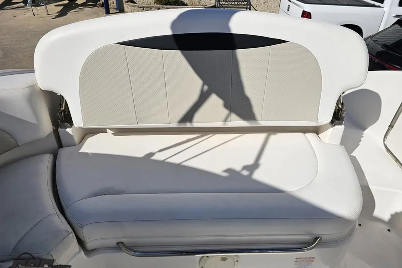 Slide: The Image of 2010 Chaparral 276 SSX boat seat with white upholstery and stainless steel railing. - 105