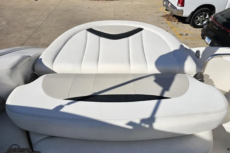 Slide: The Image of 2010 Chaparral 276 SSX boat interior with white cushioned seating. - 106