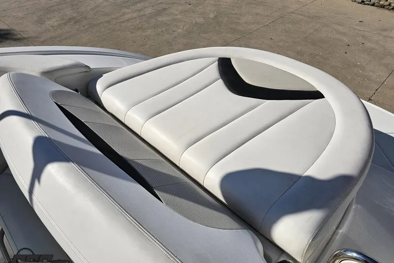 Slide: The Image of 2010 Chaparral 276 SSX boat seat with white and gray upholstery in sunlight. - 107
