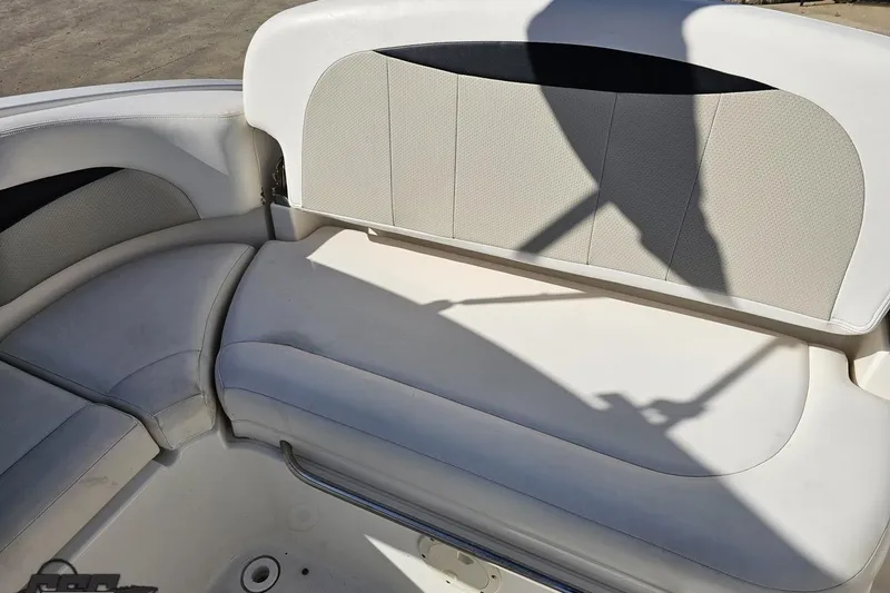 Slide: The Image of 2010 Chaparral 276 SSX boat interior seating with white upholstery and shadow. - 108