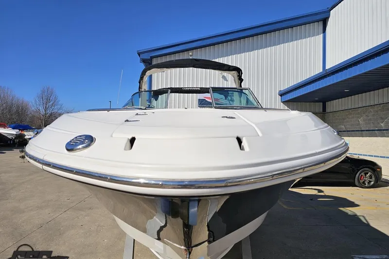 Slide: The Image of 2010 Chaparral 276 SSX boat displayed outdoors near a building. - 12