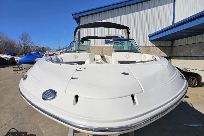Slide: The Image of 2010 Chaparral 276 SSX boat displayed outdoors near a building. - 13