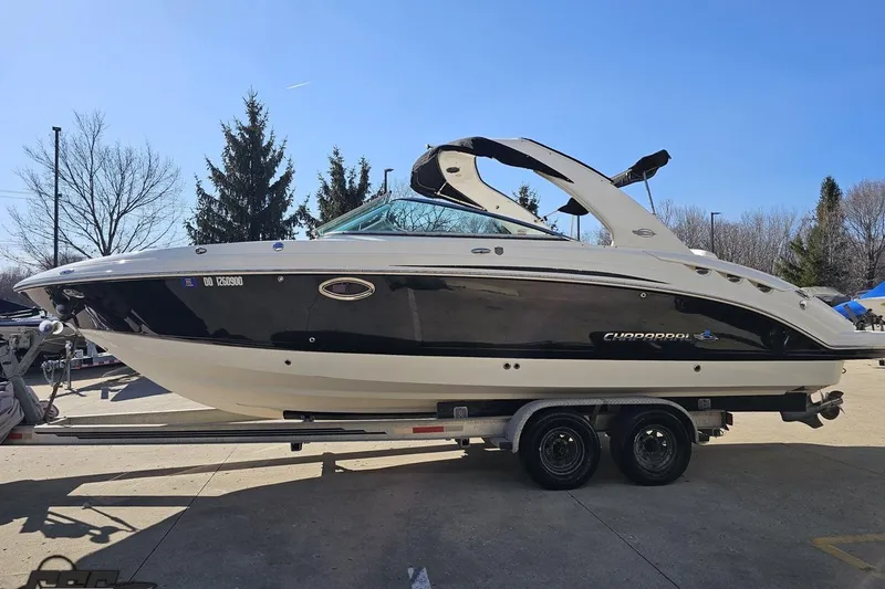 Slide: The Image of 2010 Chaparral 276 SSX boat on trailer, parked outdoors on a sunny day. - 17