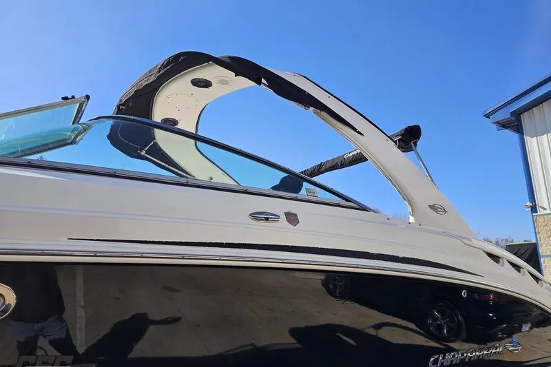 Slide: The Image of 2010 Chaparral 276 SSX boat with sleek design and modern features under clear blue sky. - 19