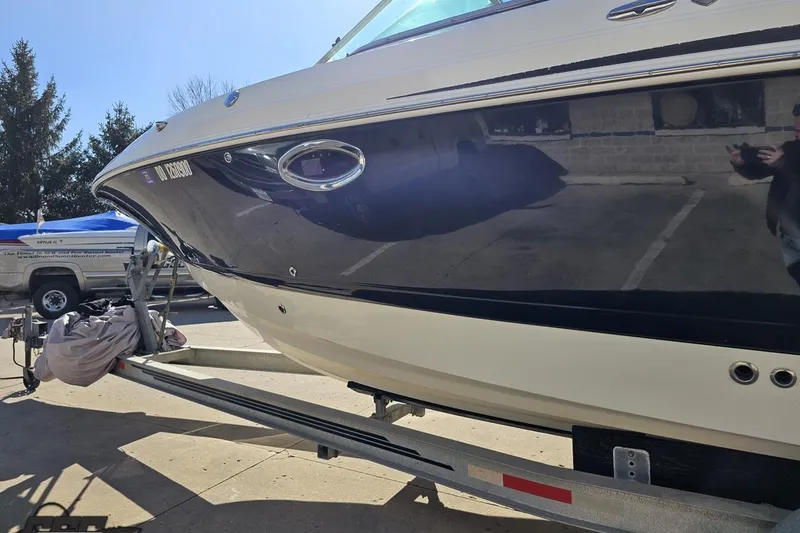 Slide: The Image of 2010 Chaparral 276 SSX boat on trailer, parked outdoors in sunny weather. - 20