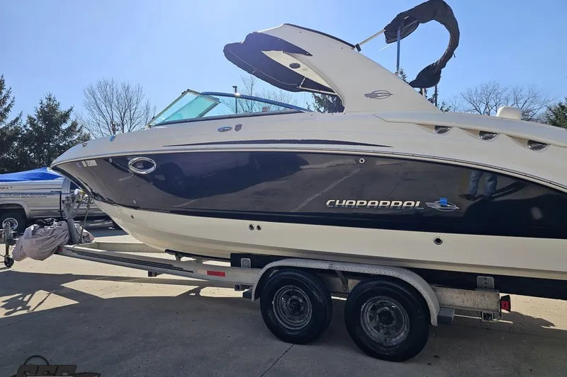 Slide: The Image of 2010 Chaparral 276 SSX boat on trailer, side view, outdoors. - 21