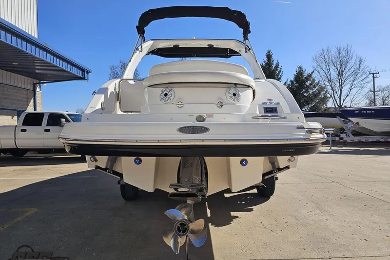 Slide: The Image of 2010 Chaparral 276 SSX boat rear view, parked outdoors on a sunny day. - 24