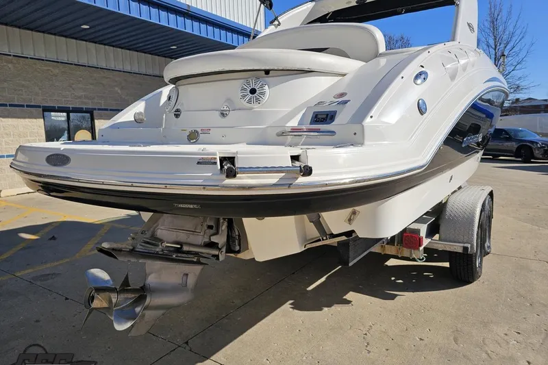 Slide: The Image of 2010 Chaparral 276 SSX boat on trailer, rear view, showcasing propeller and sleek design. - 27