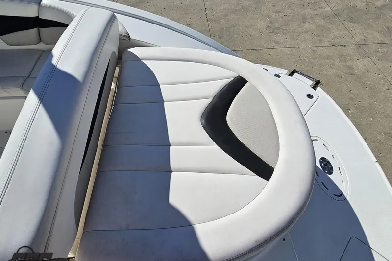 Slide: The Image of 2010 Chaparral 276 SSX boat interior with white cushioned seating. - 32