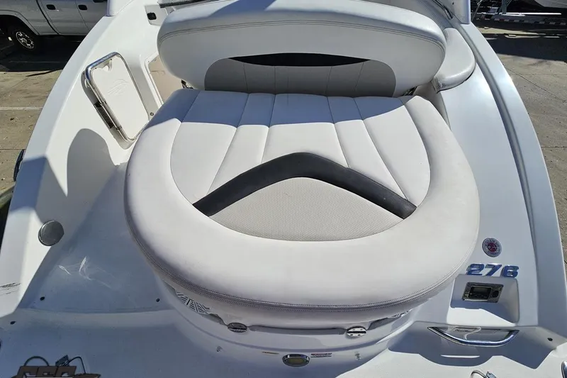 Slide: The Image of 2010 Chaparral 276 SSX boat with white cushioned seating area. - 34