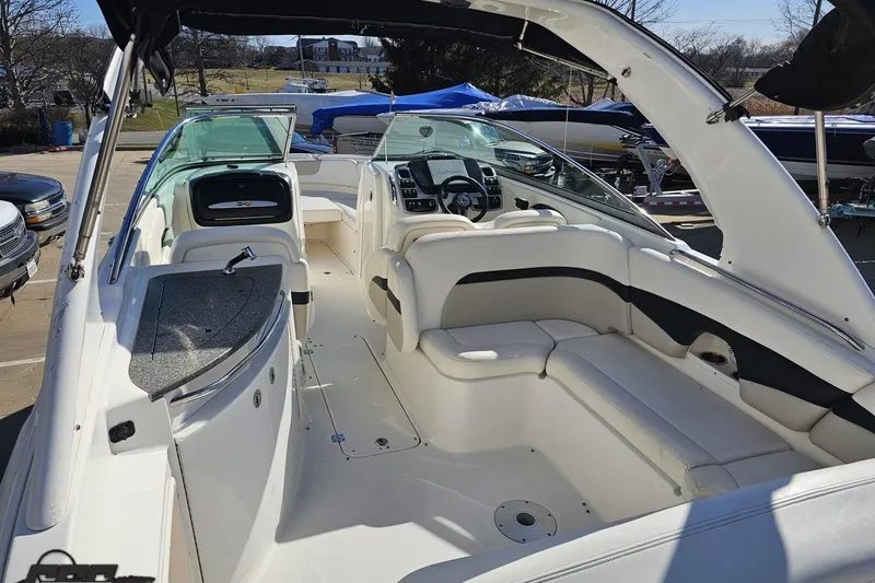 Slide: The Image of 2010 Chaparral 276 SSX boat interior with white seating and modern dashboard. - 39