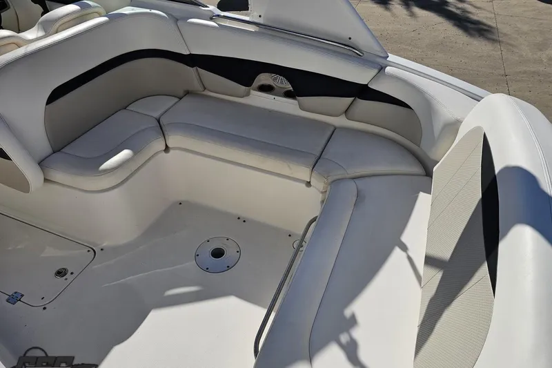 Slide: The Image of Interior seating of a 2010 Chaparral 276 SSX boat, featuring white and black upholstery. - 40