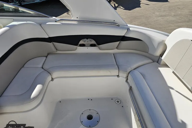Slide: The Image of 2010 Chaparral 276 SSX boat interior with white cushioned seating. - 41