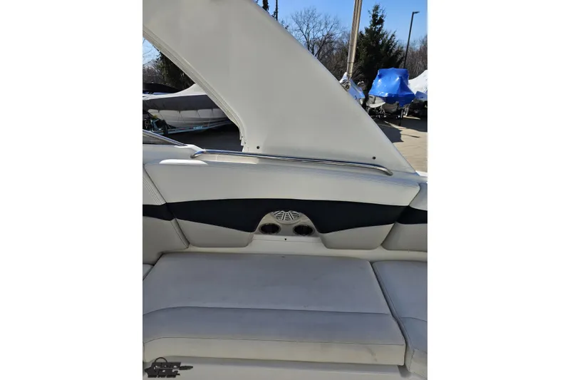 Slide: The Image of 2010 Chaparral 276 SSX boat interior with cushioned seating and speaker detail. - 42