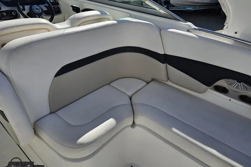 Slide: The Image of Interior seating of a 2010 Chaparral 276 SSX boat, featuring white and black upholstery. - 44