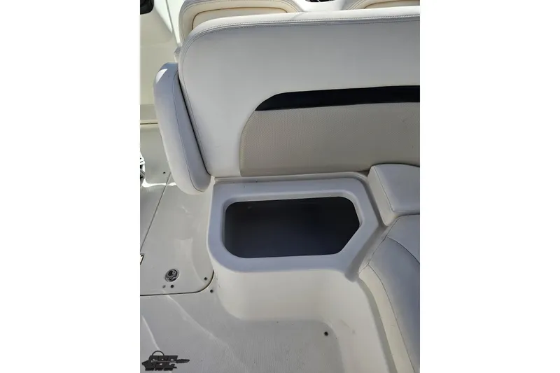 Slide: The Image of 2010 Chaparral 276 SSX boat interior with white seating and built-in storage compartment. - 45